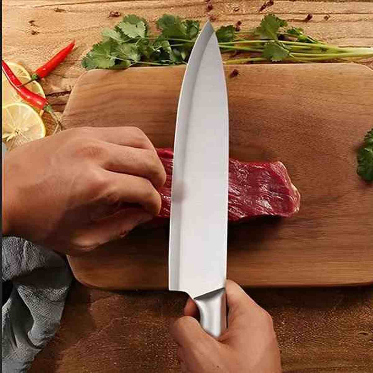 Couteau de chef japonais en acier inoxydable avec manche ergonomique posé sur une planche à découper en bois clair
